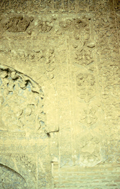 Detail of the mihrab hood and frame, showing floral stucco carvings