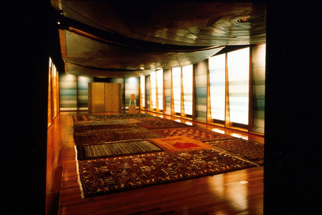 Interior view, showing woodwork and plays of light in multi-purpose room dressed with carpets