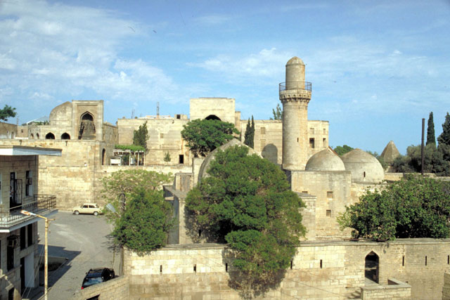 Exterior view showing stone minaret and pishtaqs
