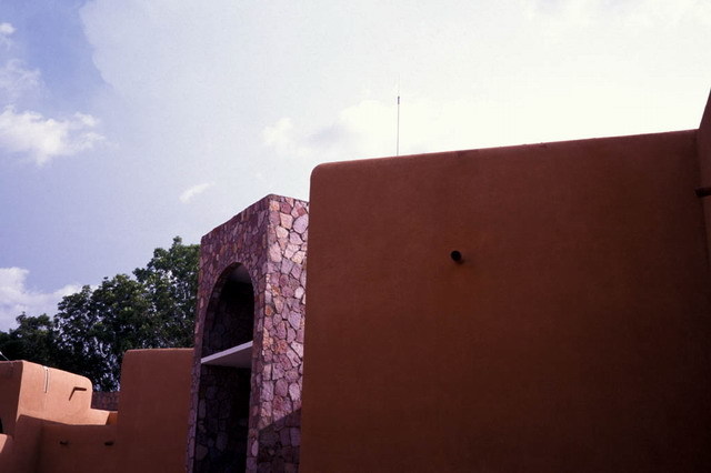 Exterior view; clay-finished and stone walls