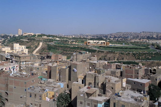 View looking east across neighborhood rooftops towards the Lakeside Café in the Al-Azhar Park