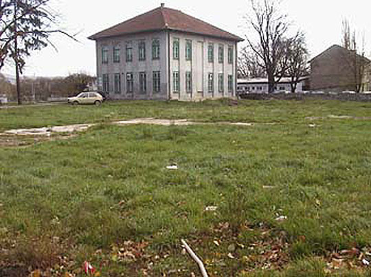 The empty site of the mosque with the outline of its foundation in the foreground and the Mufti's office in the background, after it was bombed and bulldozed in May 1993 by Bosnian Serb extremists