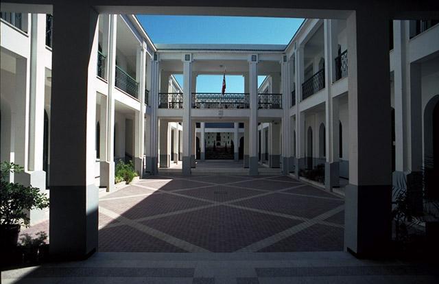 Paved courtyard is surrounded by a two-storey covered gallery