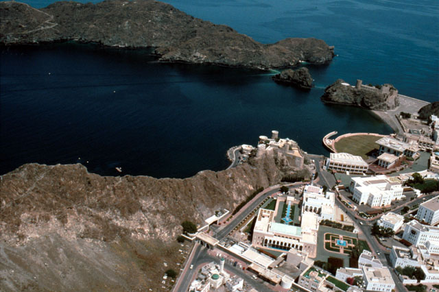 Muscat Old Town Rehabilitation - Aerial view showing complex abutting mountain-ridge along harbor