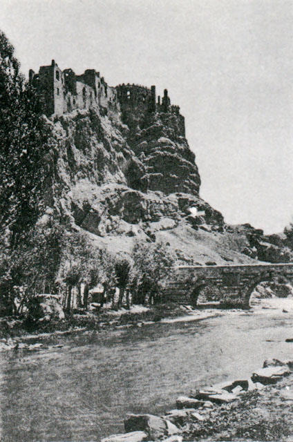 Exterior view from southwest showing the castle at top of hill, with Hosap river and bridge seen below