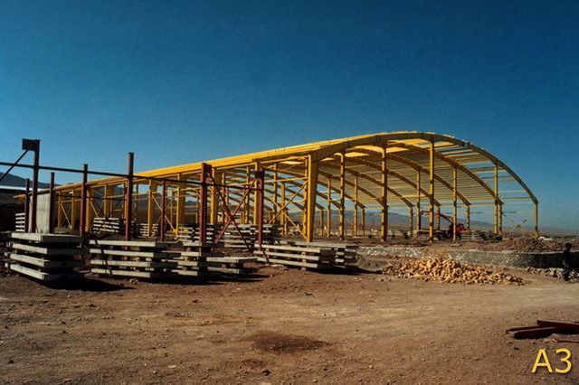 Exterior view, during construction, showing curved steel structure