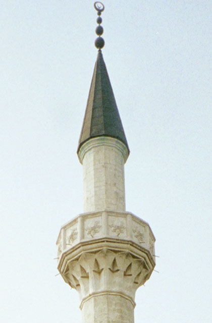 Detail view of minaret, showing balcony and crown
