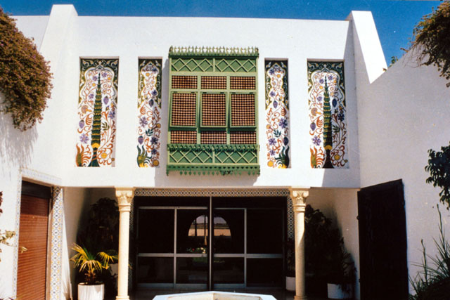 Exterior view of entrance and upper story mashrabiyya and decorative tile work