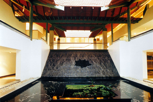 Interior view showing pool against pierced wooden ceiling, its opening reveals the clay roof