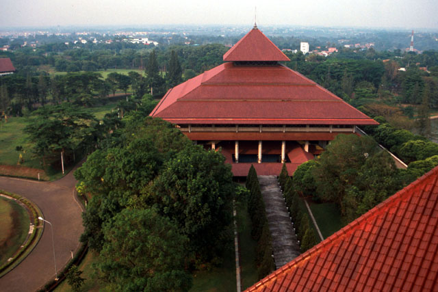 Aerial view showing tree lined path between pagoda roofed buildings