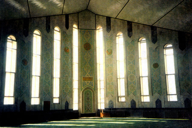 Interior view of prayer hall showing tile work on walls and pitched ceiling