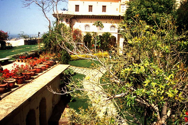 Neemrana Fort-Palace Revitalisation - Garden-entrance after restoration trees concealing much of the restoration and the rebuilt octagonal tower with a card room