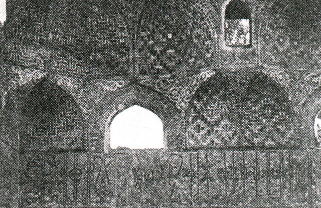 Detail of sanctuary; kufic inscriptive band below brick squinches on qibla wall