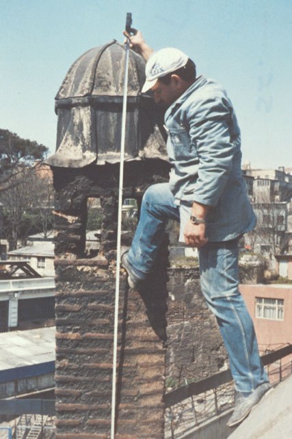 Exterior detail showing laborer measuring tower