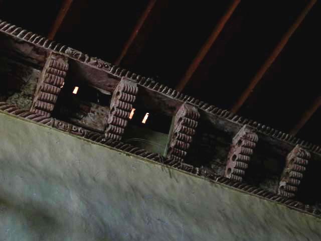 Interior detail of cornice transition between side wall and wood joist ceiling