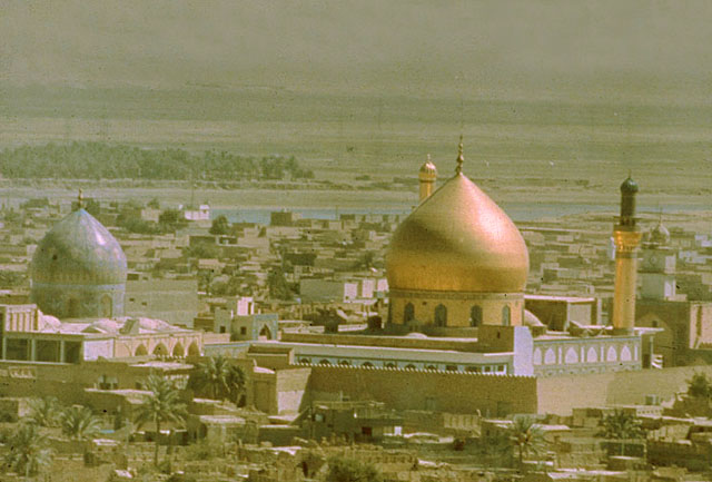 Exterior view showing the golden dome of the al-Hadi and al-Askari shrine, and the adjoining shrine of al-Mahdi with its tiled dome
