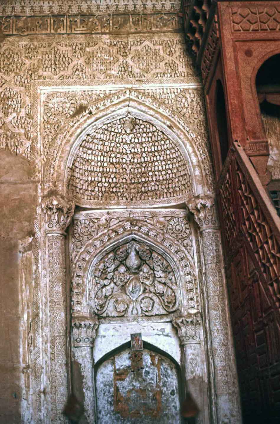 Carved, stucco mihrab, with partial view of the minbar