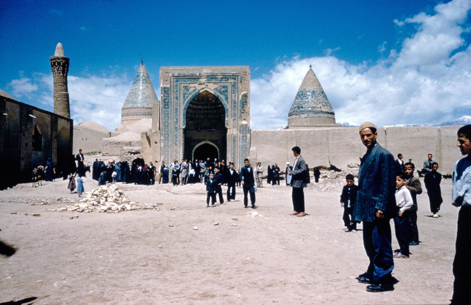 General view from east, showing the entrance iwan at the center, Gonbad-e Ghazan Khan on the right, with the dome of Emamzad-e Mohammad and the minaret of the mosque on the left