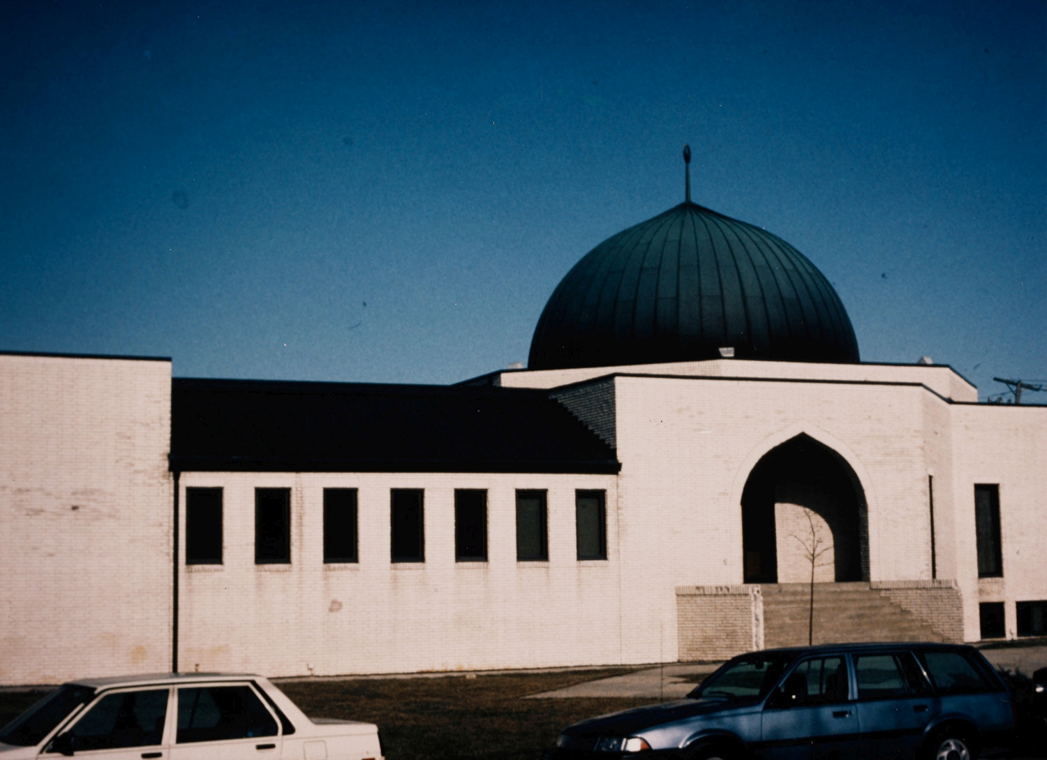 View along south facade with arched entrance; mosque prior to expansion