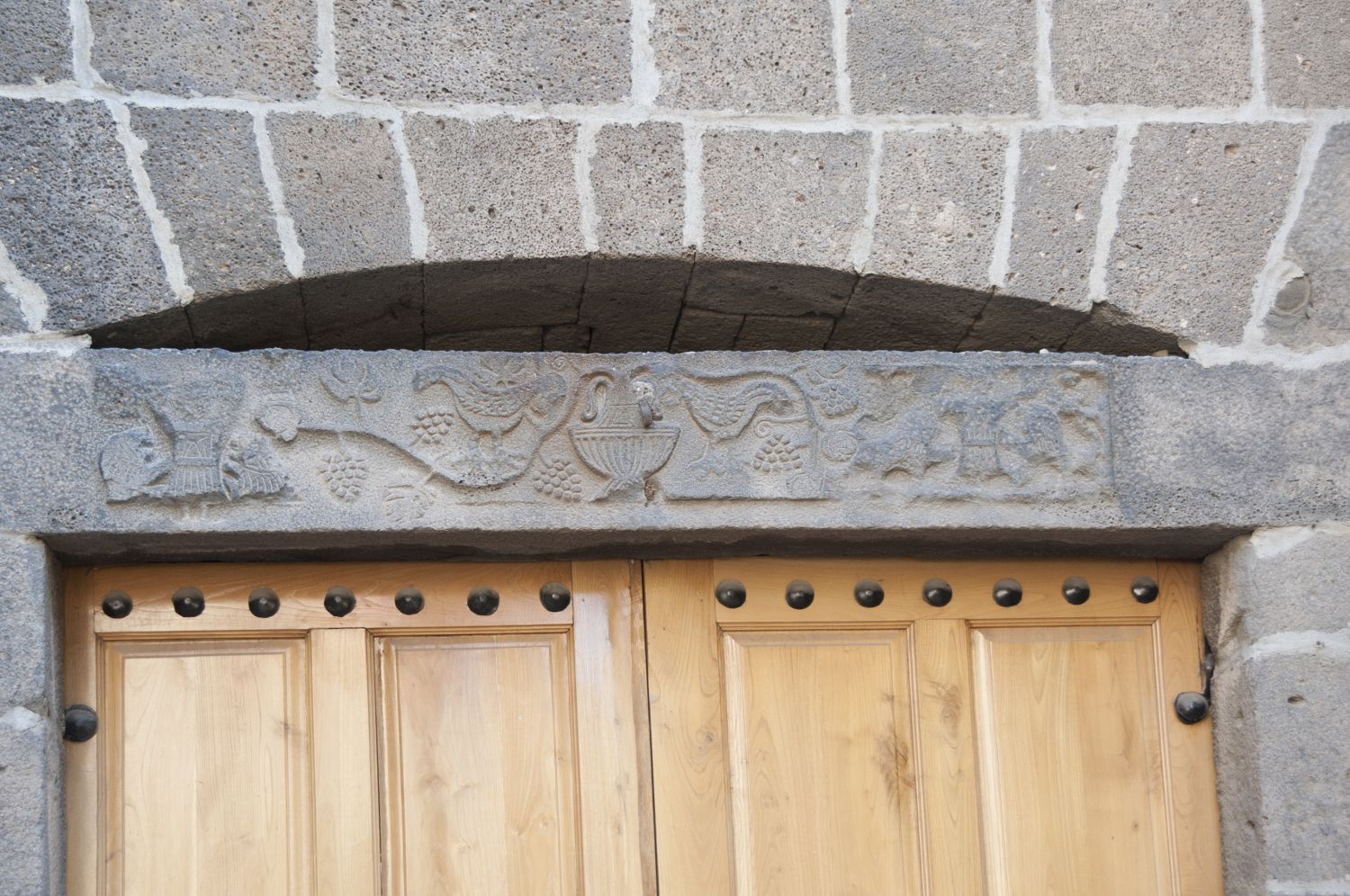 View of door lintel with carved vine scroll ornament.