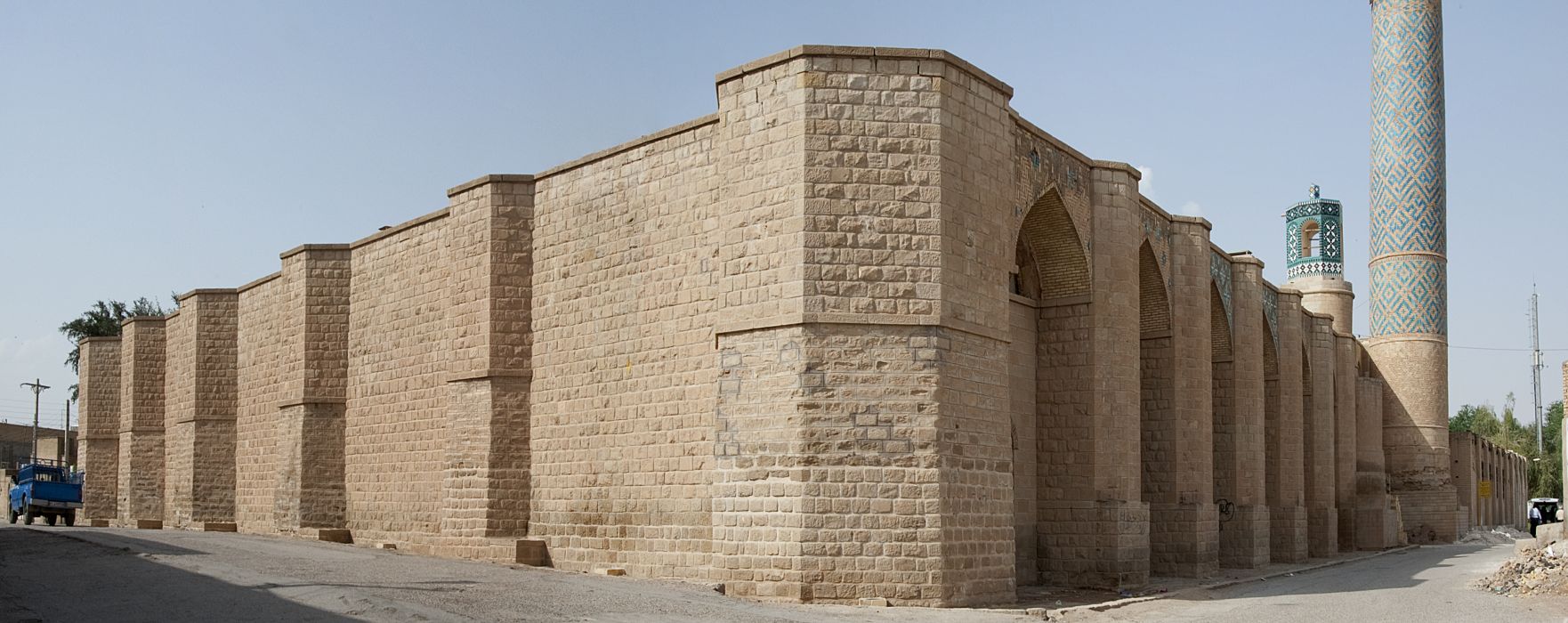 Exterior view of south corner. The buttressed qibla wall is visible at left.