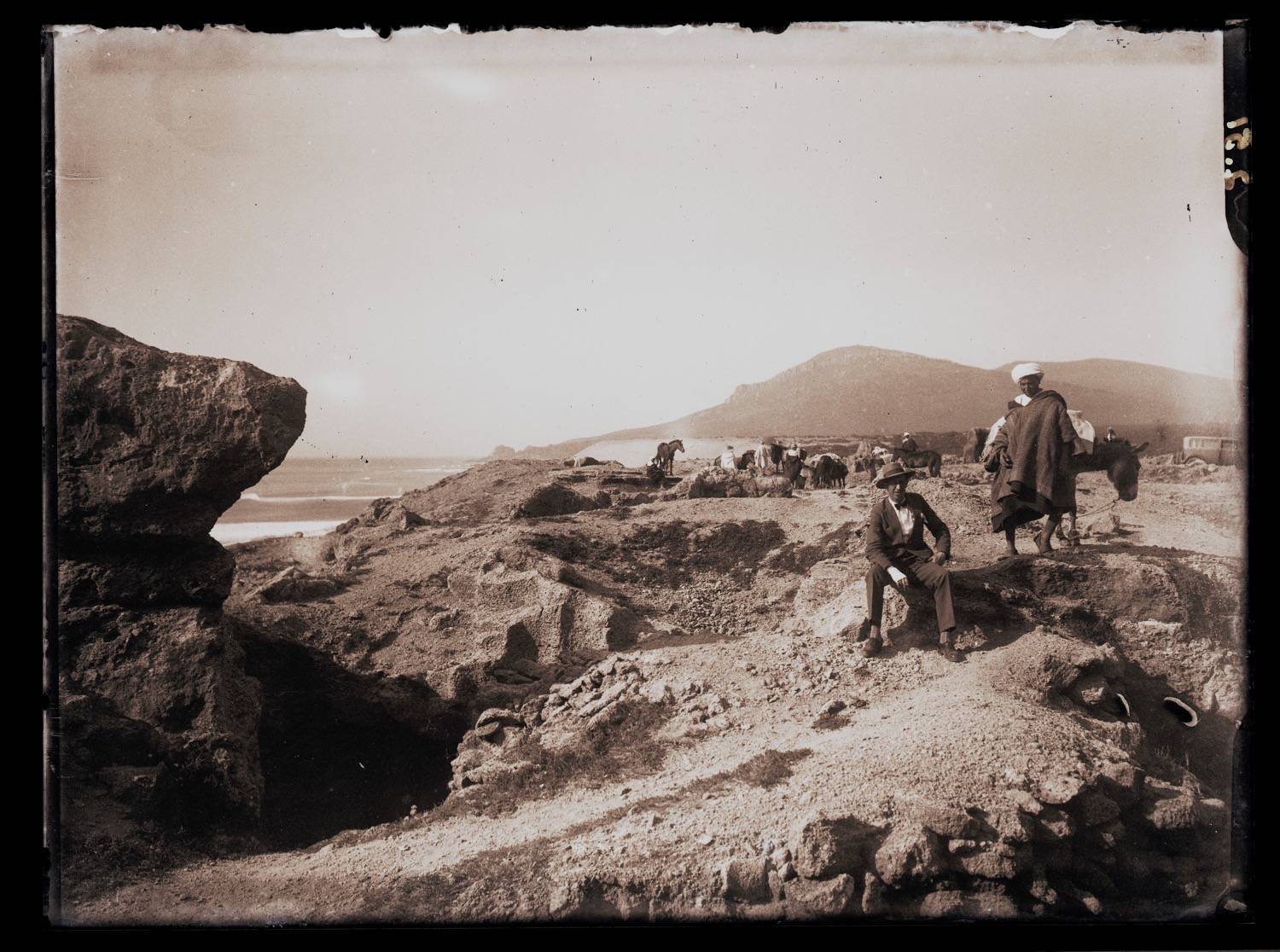 <p>Landscape view, Moroccan and European men on a trail, probably on route to Asilah</p>