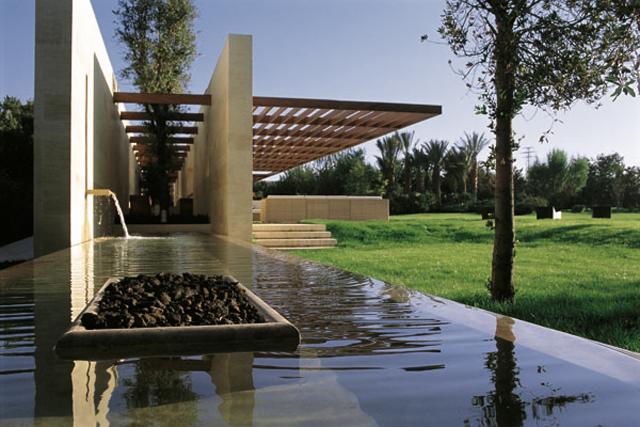 Entrance approach with fountain, fire pit and cantilevered shade structure