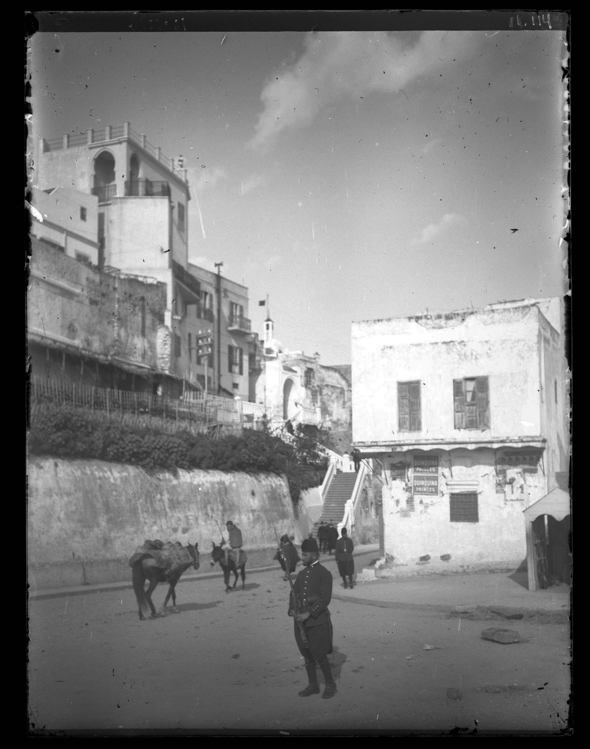 A soldier stands guard by a staircase in the Medina Walls