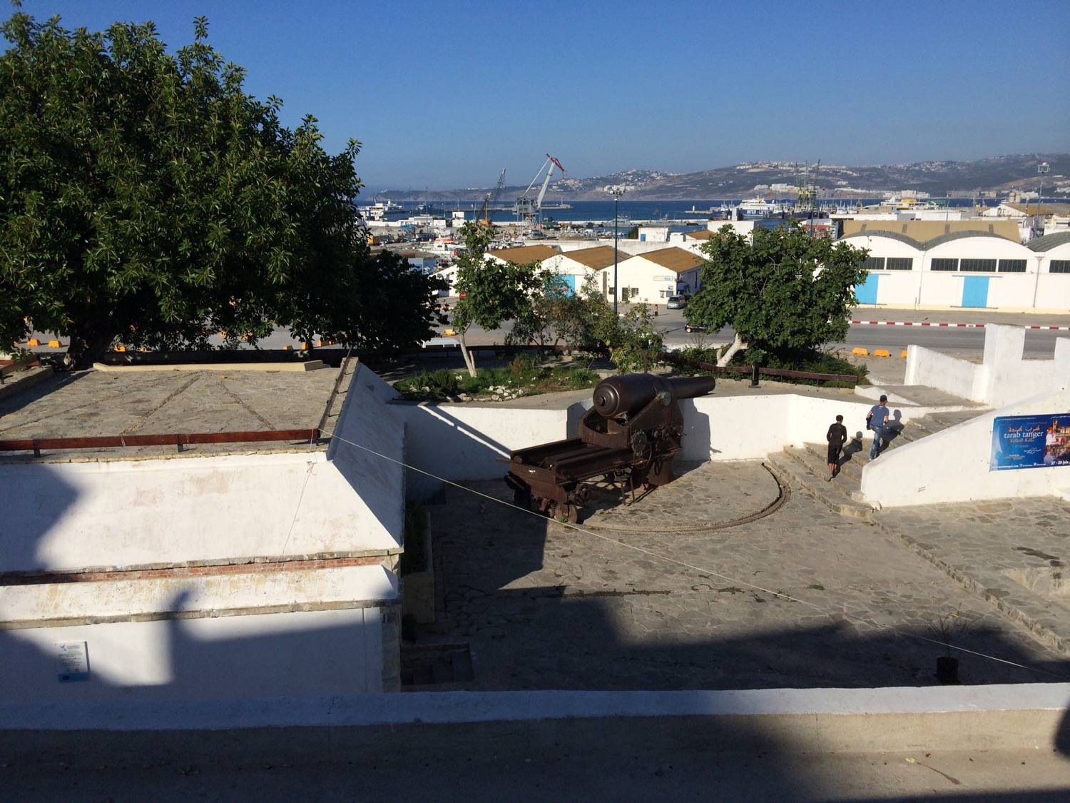 Daytime view from above of one of the Armstrong cannons and the Port of Tanger-Ville 
