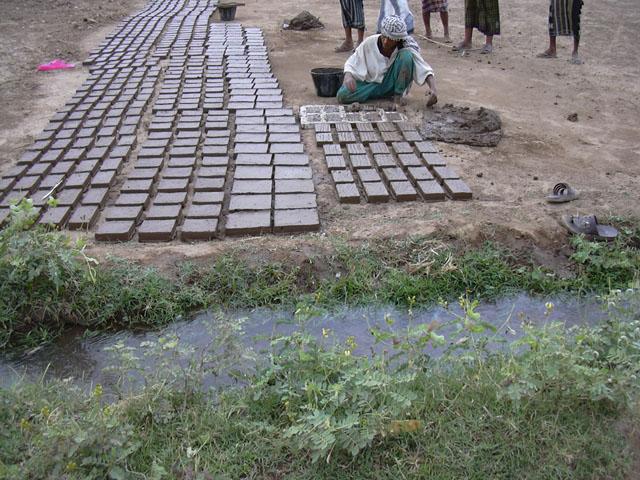 Locals fabricating the bricks using traditional methods