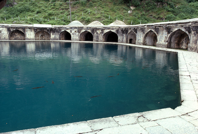 General view showing the carp-filled octagonal pool surrounded by an arched colonnade. Also visible is the stone walkway around the pool