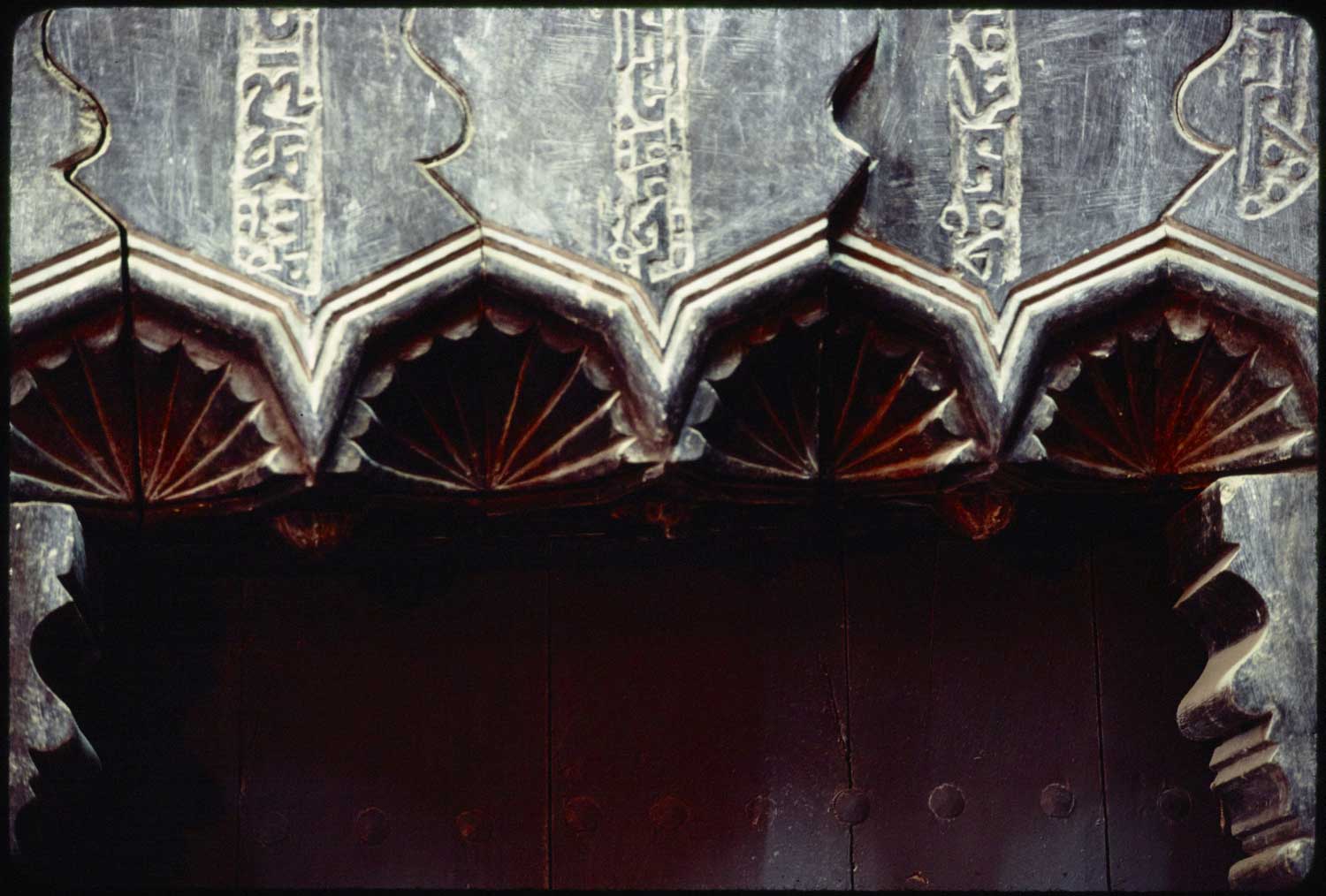 Detail of palmettes and Syriac inscriptions on the northern exterior gate.