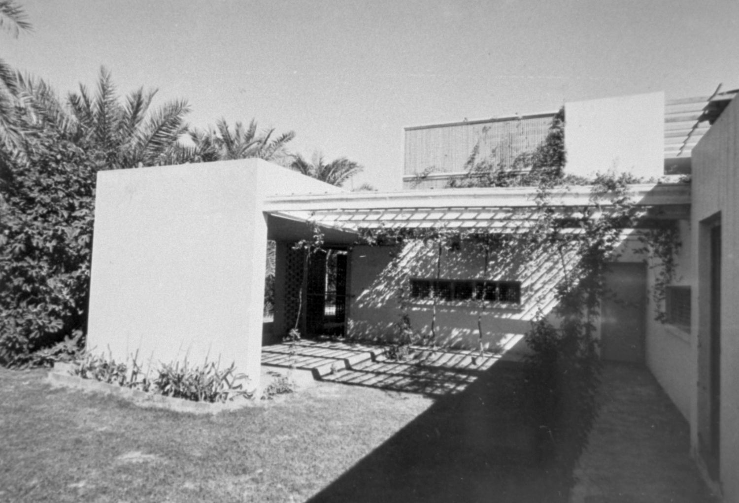 Exterior view showing side patio covered by an arbor.