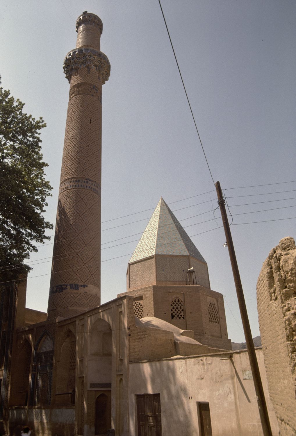 Exterior view of complex from south, showing minaret and conical roof of tomb tower.
