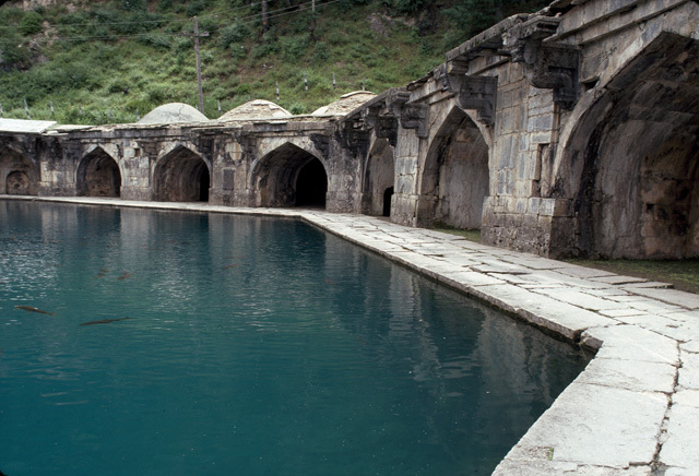 View of the carp-filled octagonal pool encircled by a stone walkway and an arched colonnade