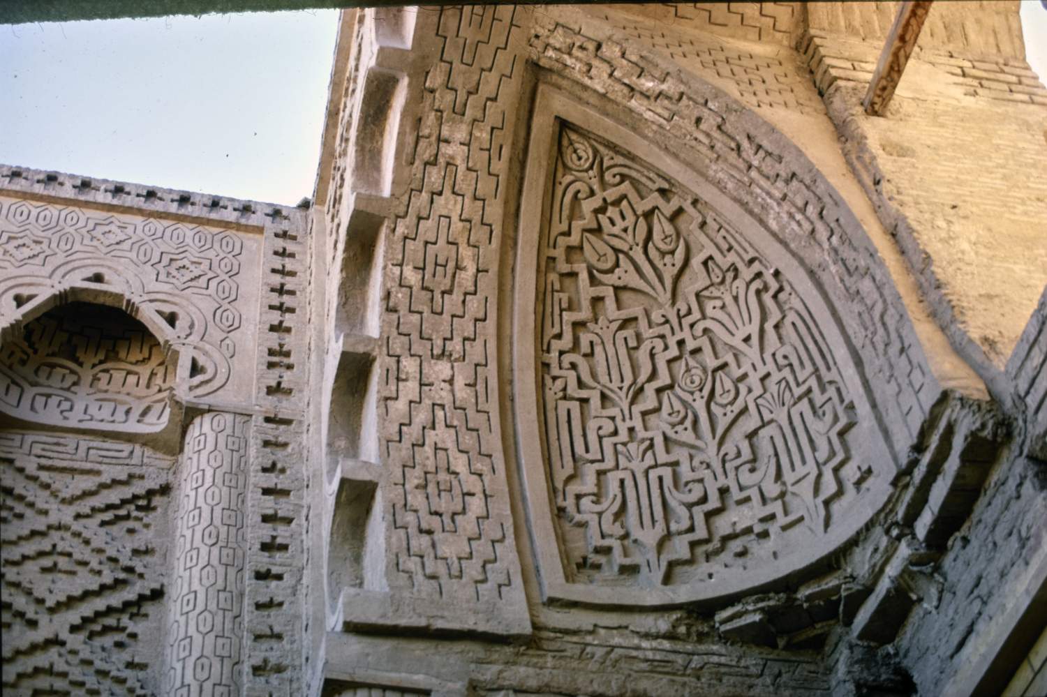 Masjid-i Jurjir - Detail of facade showing squinch with carved stucco decoration in semi-dome above entrance portal.