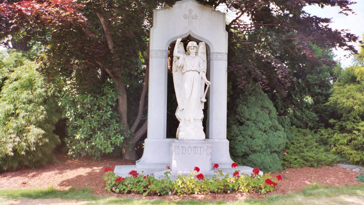 <p>View of an angel statue in at the center of Dowd family graves</p>