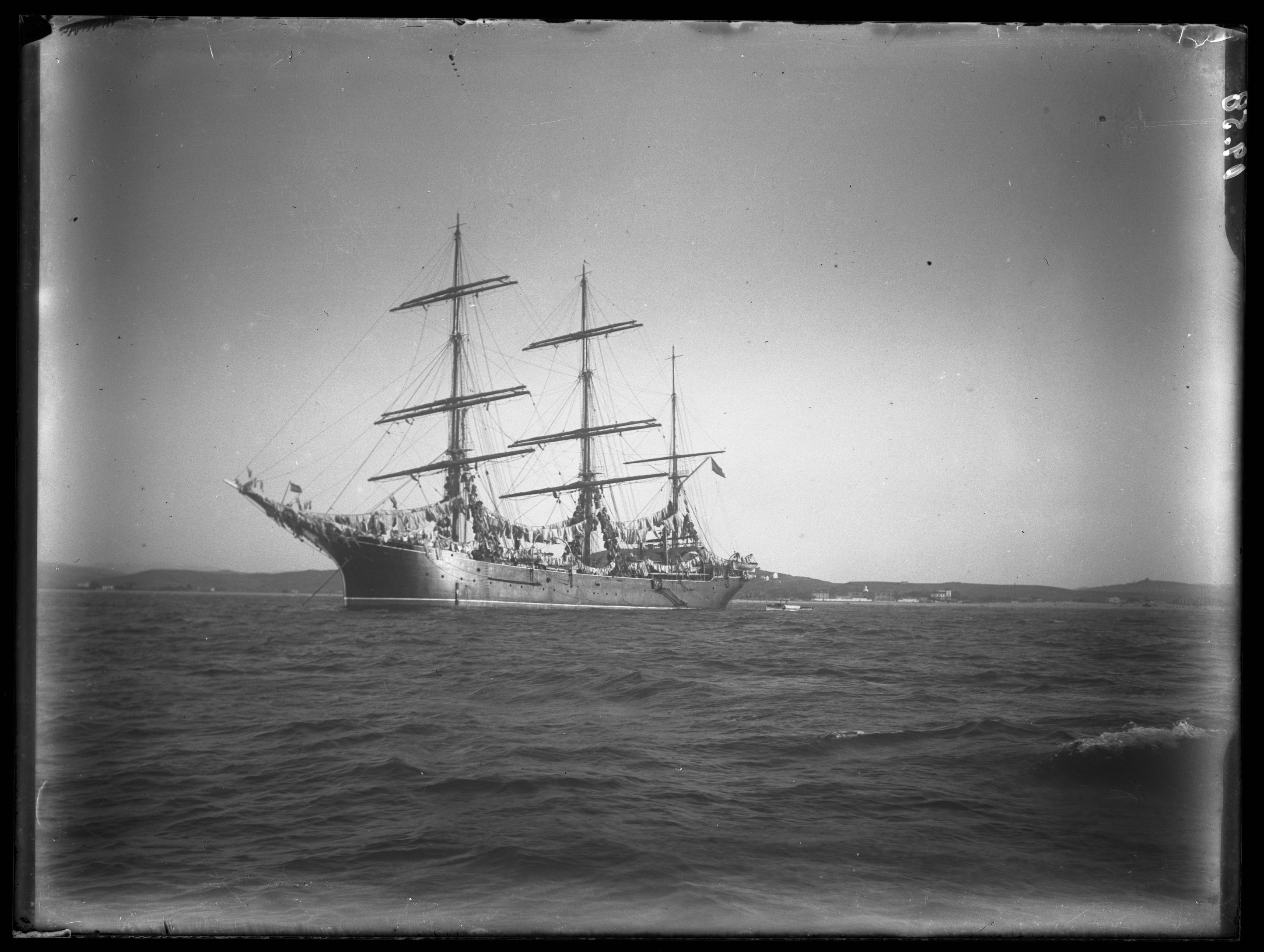 <p>View of a triple masted ship decorated with cloth pulling out of the Tangier port.</p>
