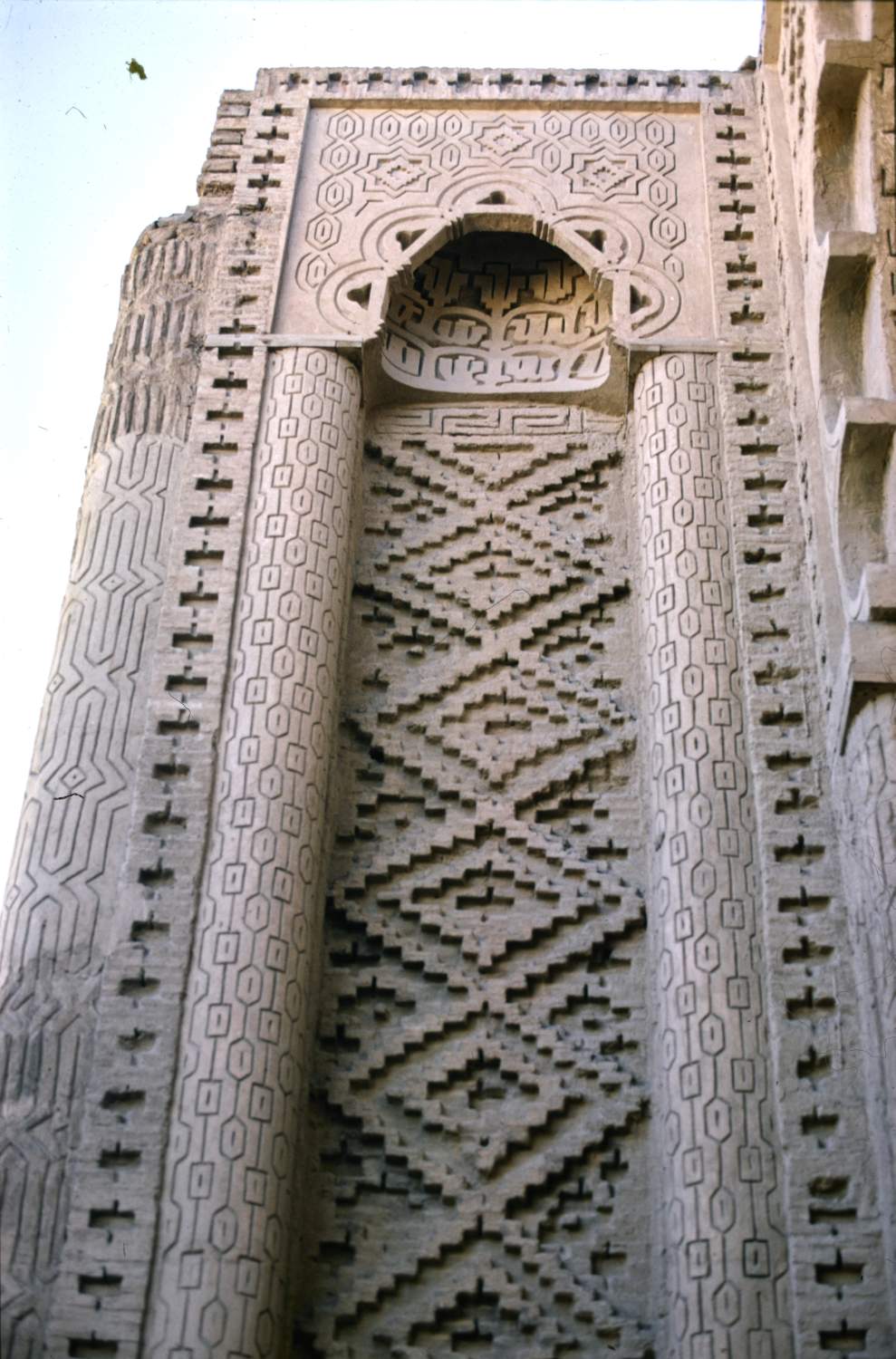 Masjid-i Jurjir - Detail of facade showing tall blind niche flanking entrance portal on left side.