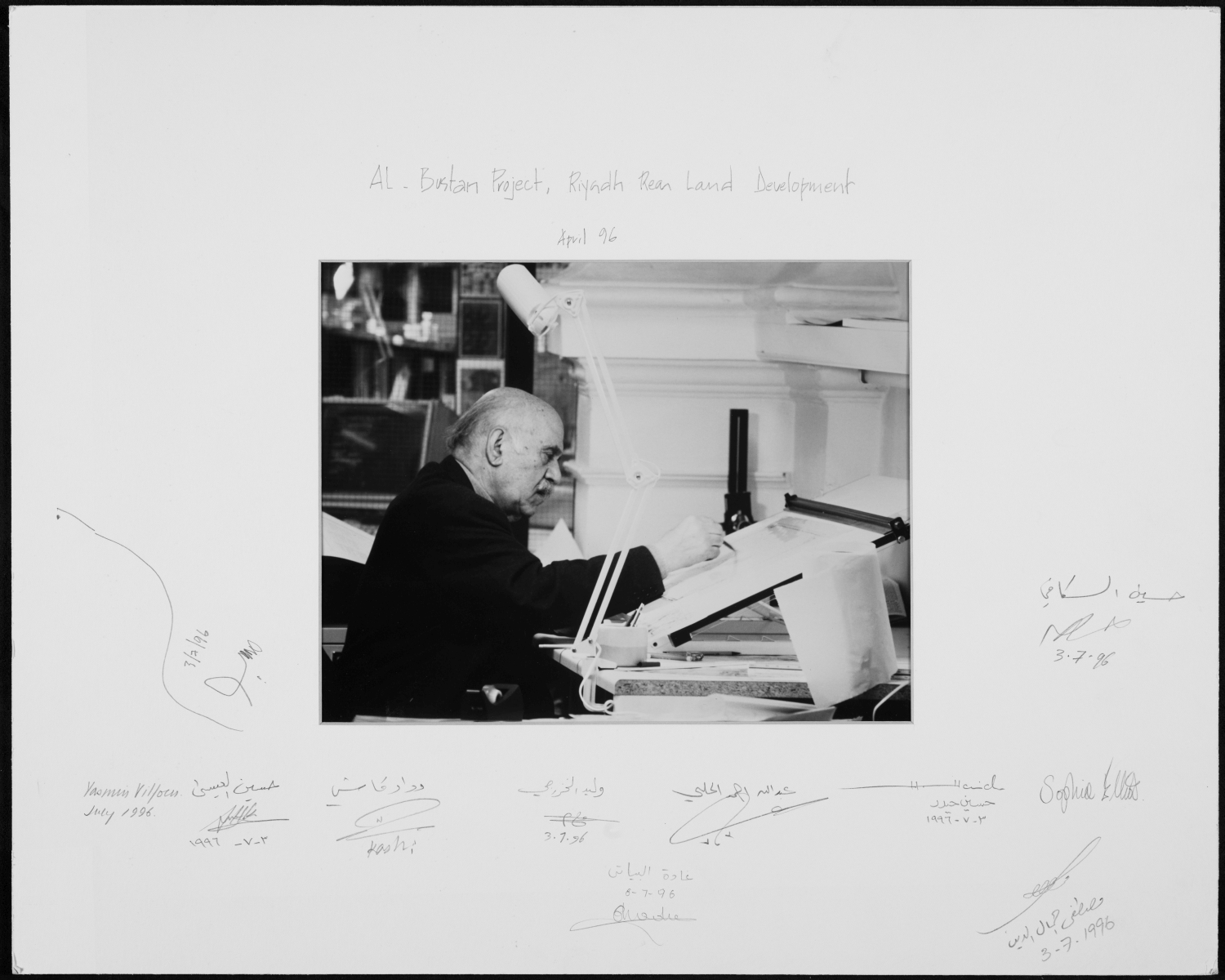 Mohamed Makiya - <p>April 1996 photo board showing Makiya at his drawing table, signed by staff members in commemoration of the Al-Bustan Project, Riyadh Rear Land Development</p>