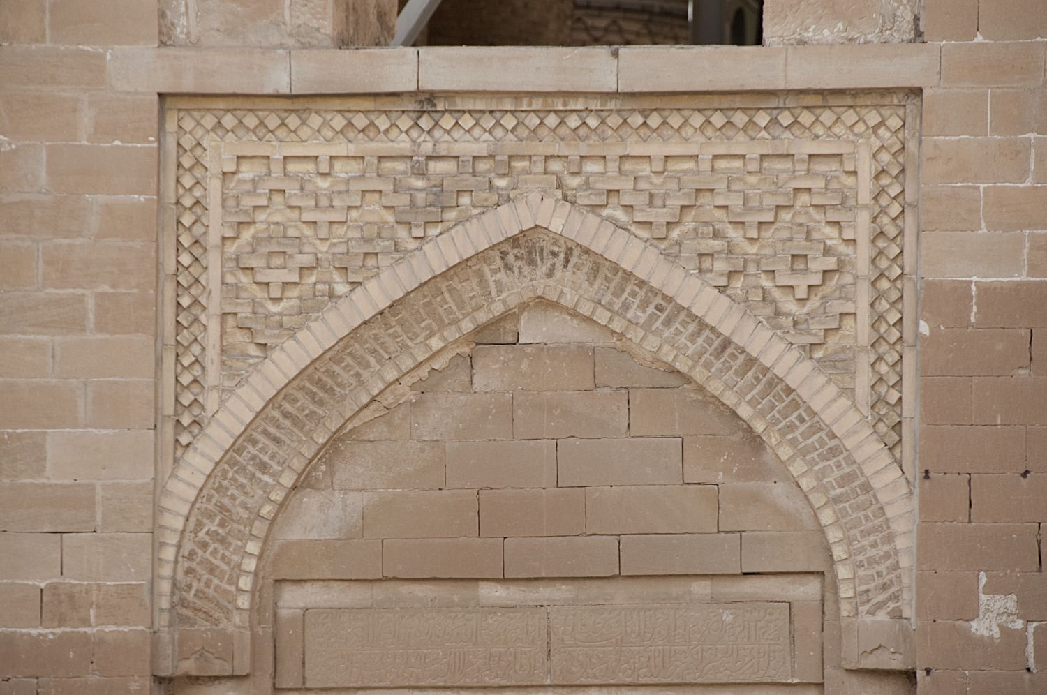 View of a lunette and spandrel decoration in brick over a portal.&nbsp;