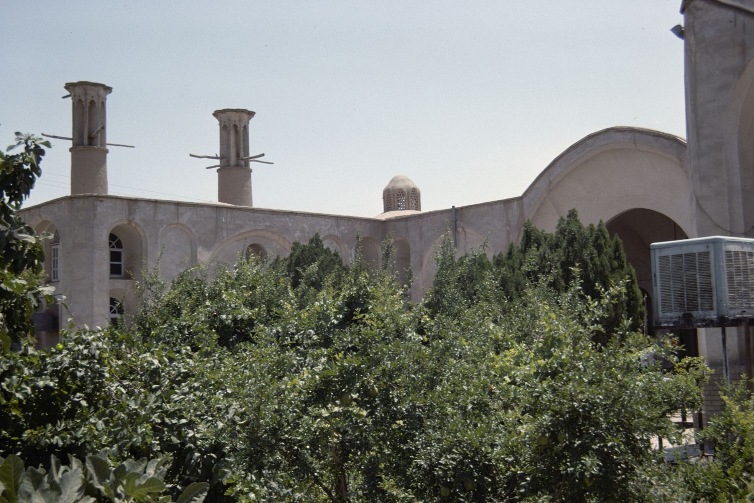 Khanah-i Yiganah - View toward house over trees in courtyard.