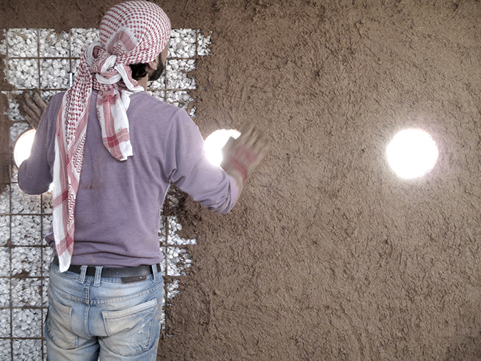 Plastering the walls by refugees  