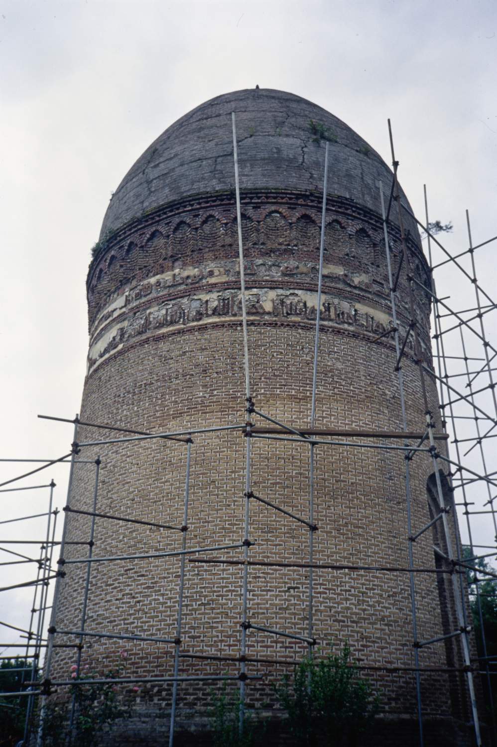 Exterior view showing inscription bands. Scaffolding for a restoration project surrounds the building.&nbsp;