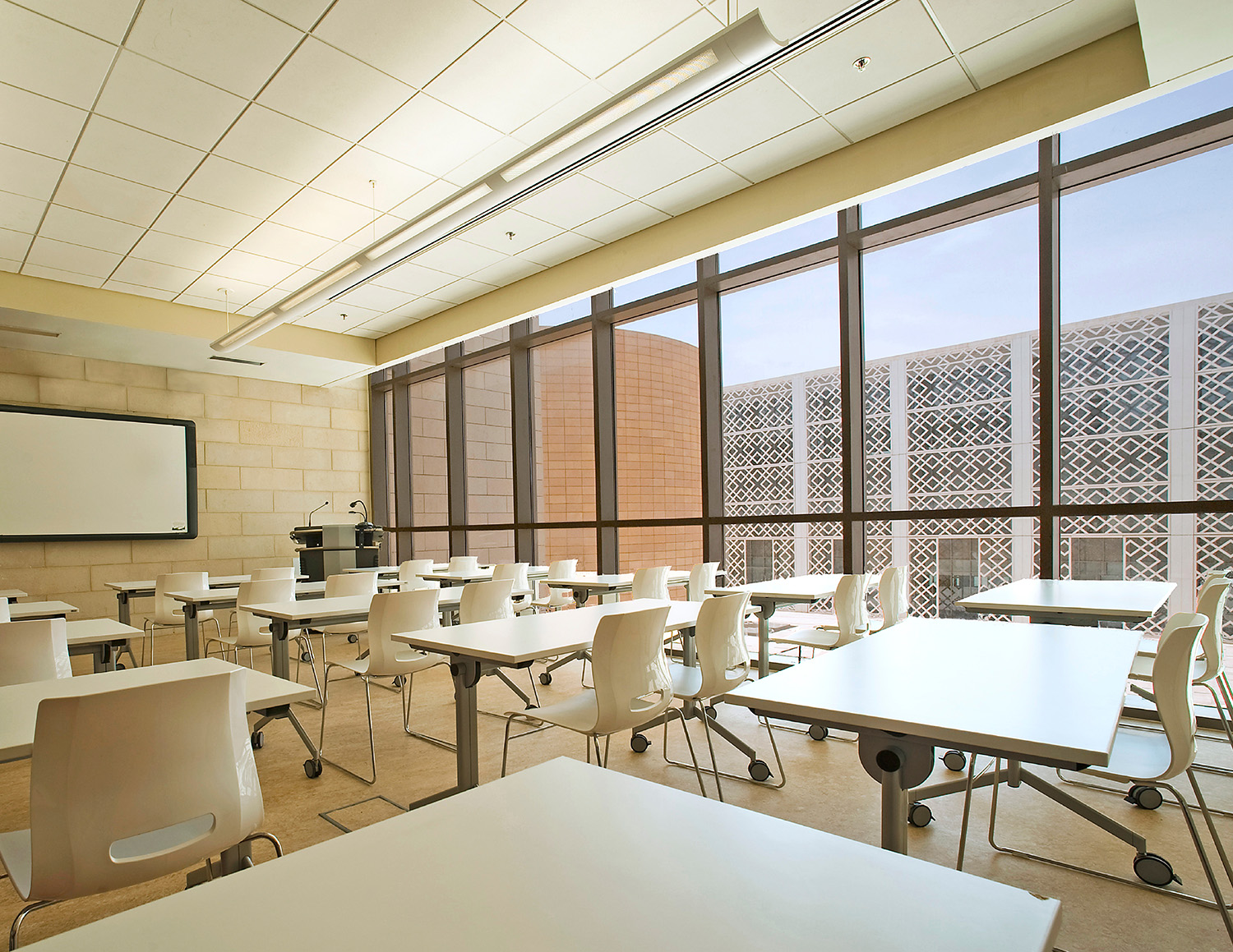 A seminar room at the College of Arts, Humanities and Sciences overlooking a student life courtyard  