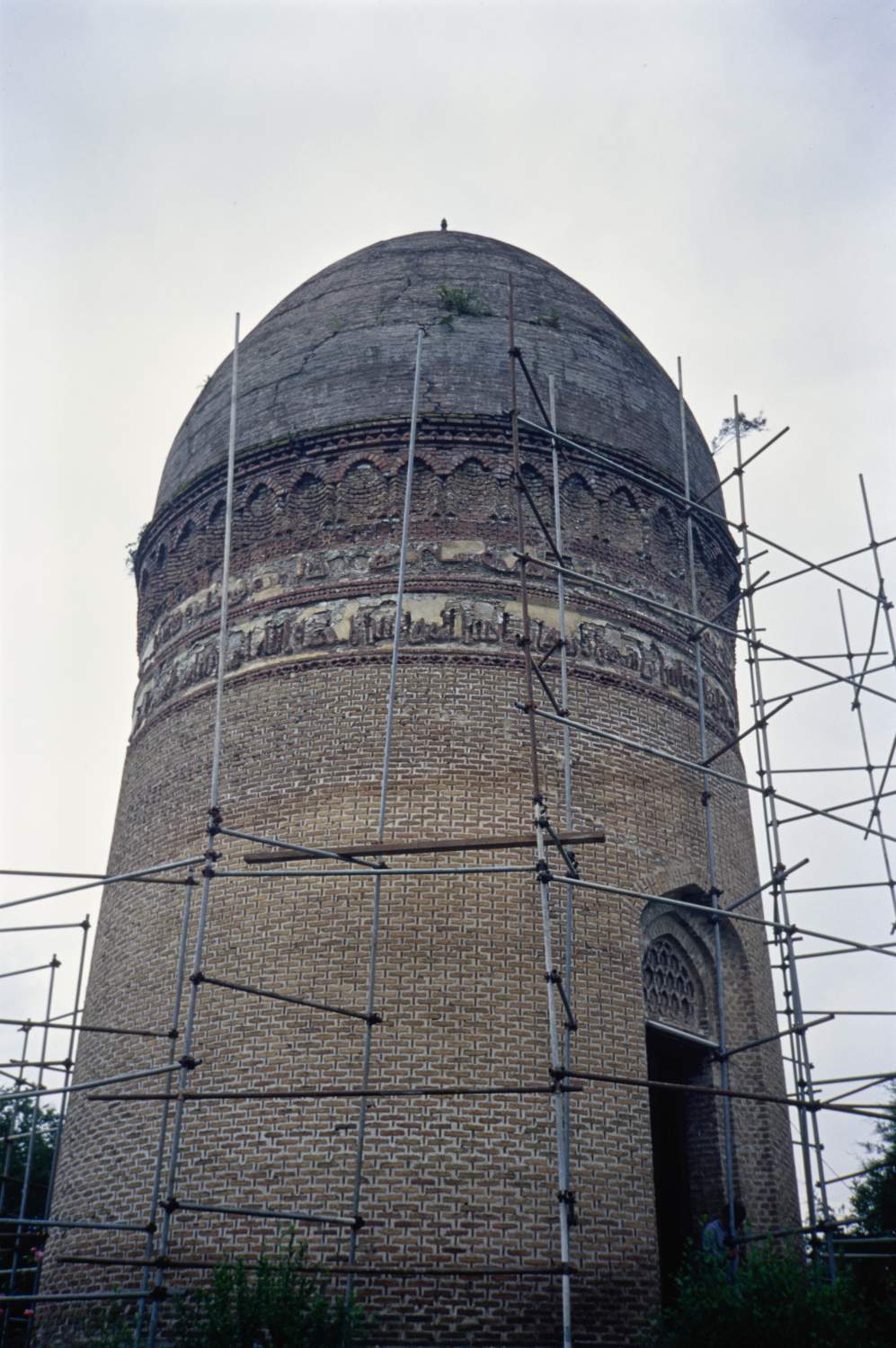 Exterior view showing inscription bands and entrance. Scaffolding for a restoration project surrounds the building.&nbsp;