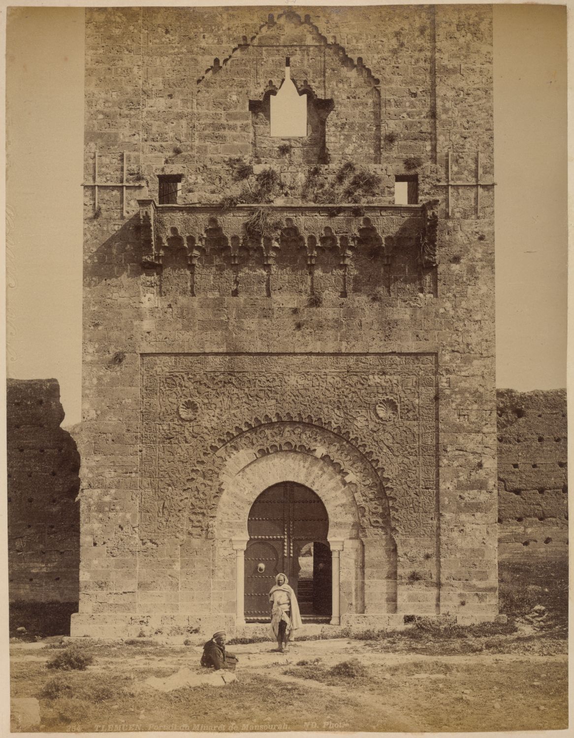 View of the minaret's base, men in front
