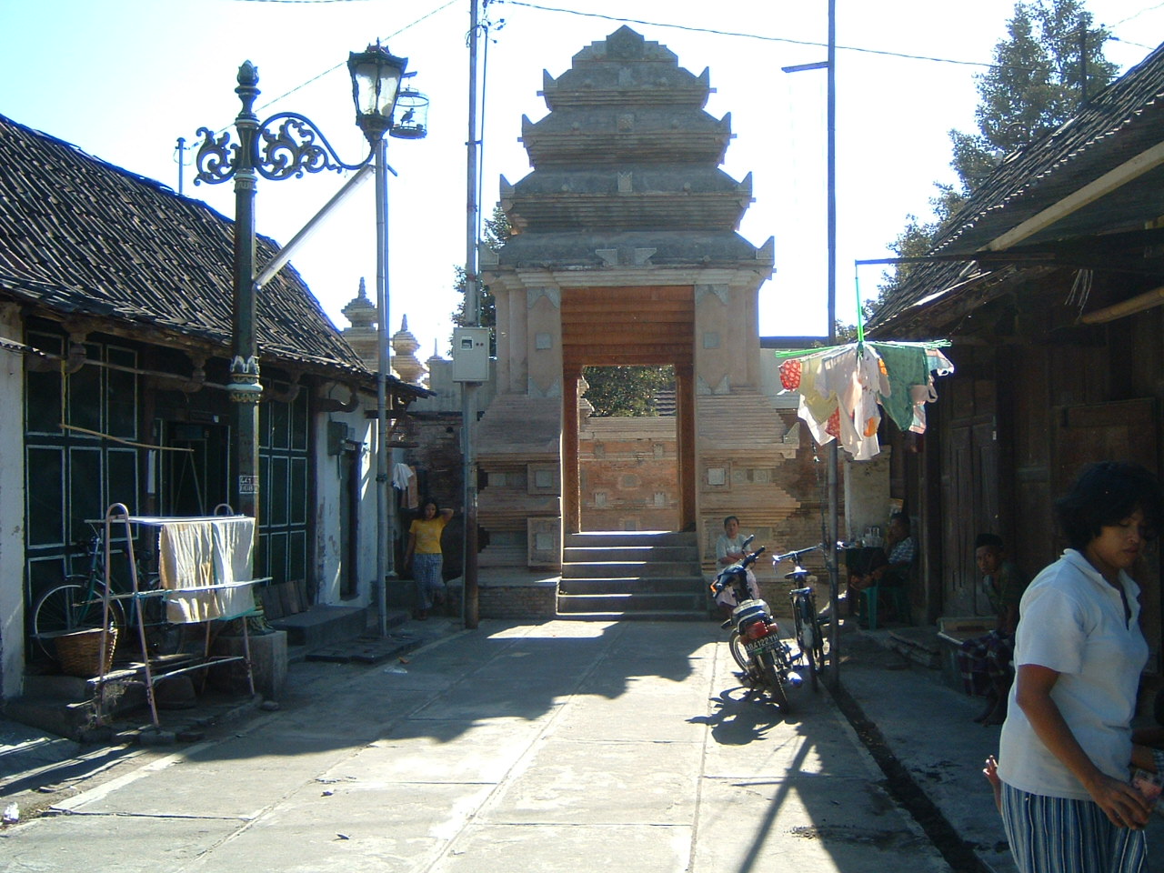 Exterior view of the gateway to the mosque and the cemetery through alleyway flanked with houses