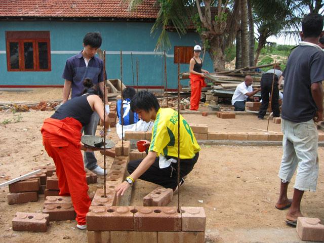 Students participating in the construction on site