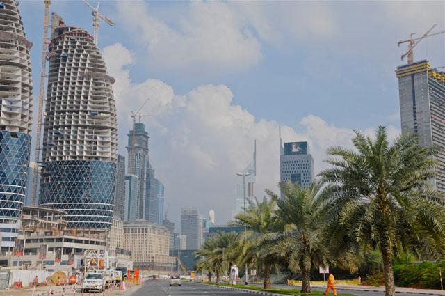 Street view showing  to the left the 'Park towers' while under construction and the 'Ritz Carlton' hotel, to the right Burj Daman overlooking the Emirates Towers